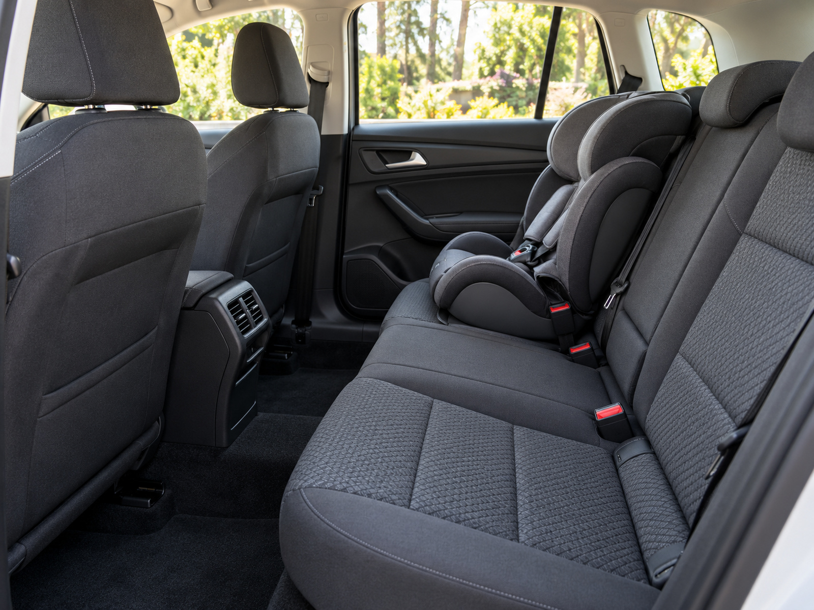 Clean fabric car seats and child seat after deep interior cleaning, soft light